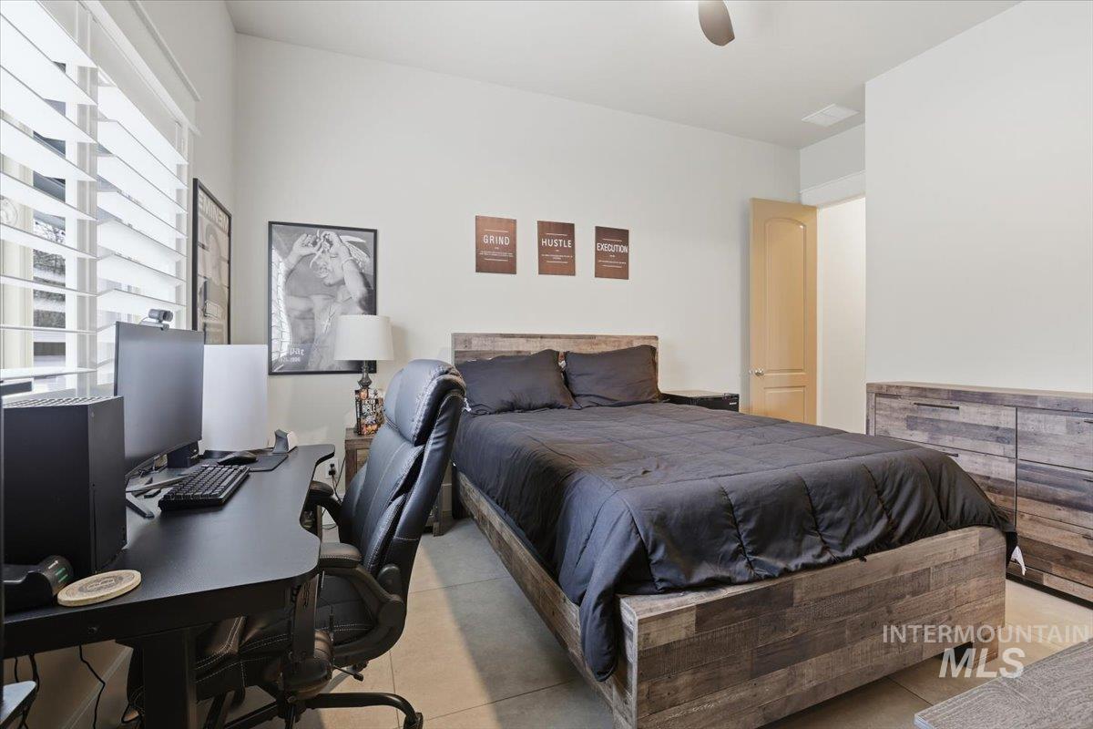 6590 North Fairborn Avenue Meridian, ID 83646 - Photo 35 of 49 Bedroom featuring ceiling fan and a desk
