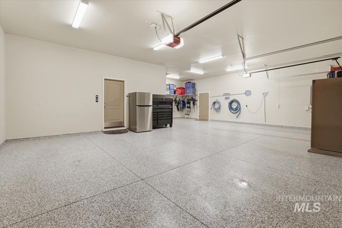 6590 North Fairborn Avenue Meridian, ID 83646 - Photo 44 of 49 Garage featuring freestanding refrigerator and a garage door opener