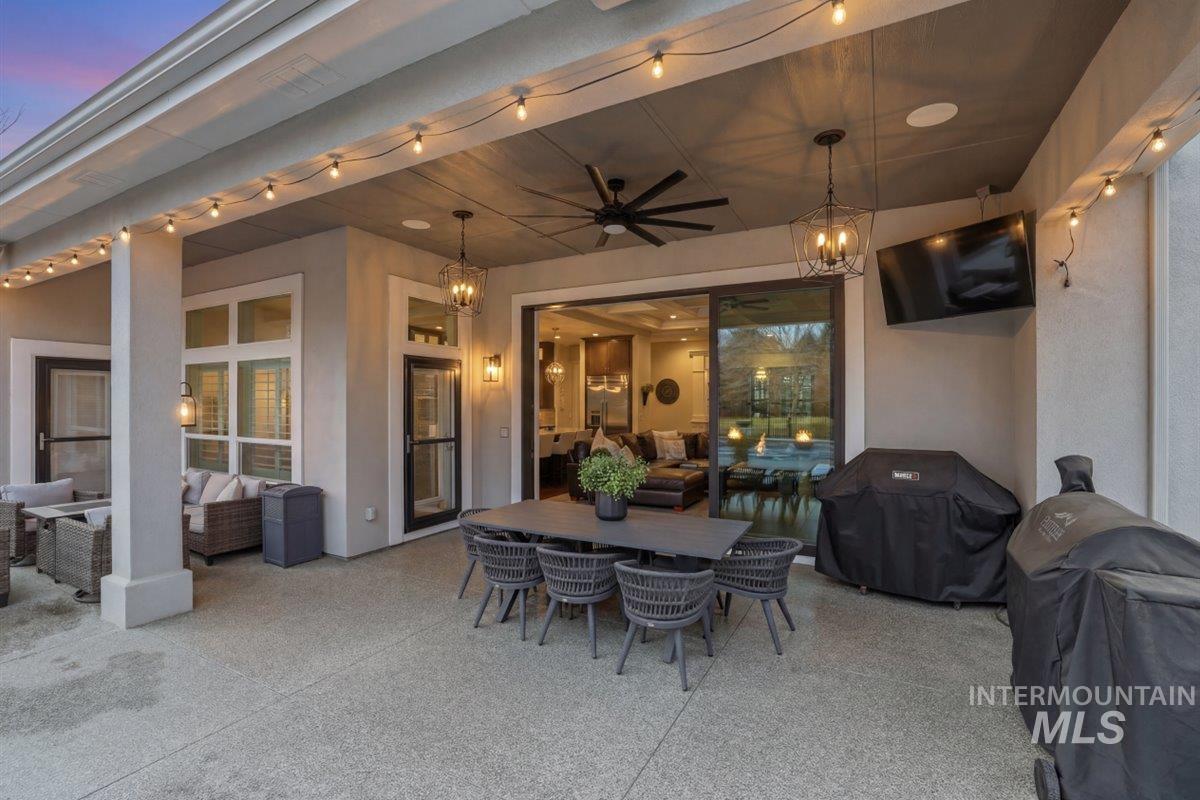 6590 North Fairborn Avenue Meridian, ID 83646 - Photo 7 of 49 Patio terrace at dusk with an outdoor living space, outdoor dining area, a grill, ceiling fan, and a patio area