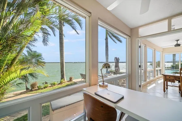 a view of swimming pool with outdoor seating and a palm tree