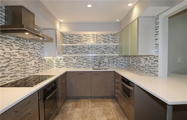 a kitchen with stainless steel appliances a sink and cabinets