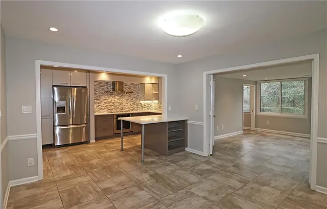 a view of a hallway with wooden floor and closet