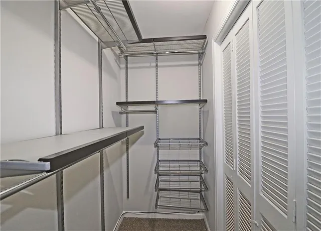 a view of a room with a ceiling fan and window