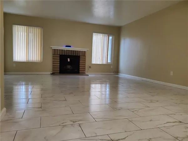 a view of an empty room with glass door and glass door