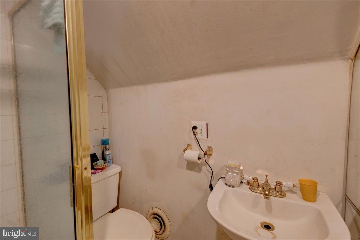 7306 Dogwood Road Baltimore, MD 21244 - Photo 20 of 37 Cozy bathroom with unique sloped ceiling.