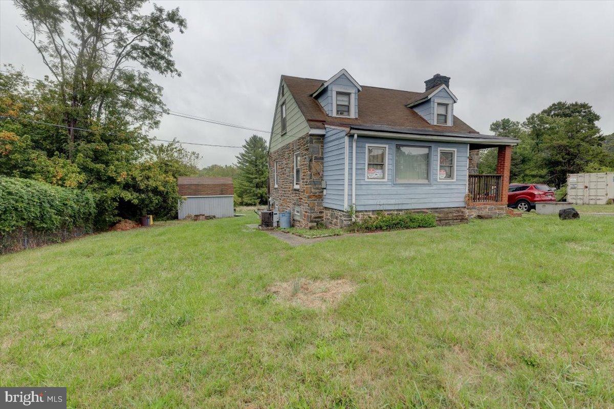 7306 Dogwood Road Baltimore, MD 21244 - Photo 2 of 37 Charming blue home with lush green surroundings.