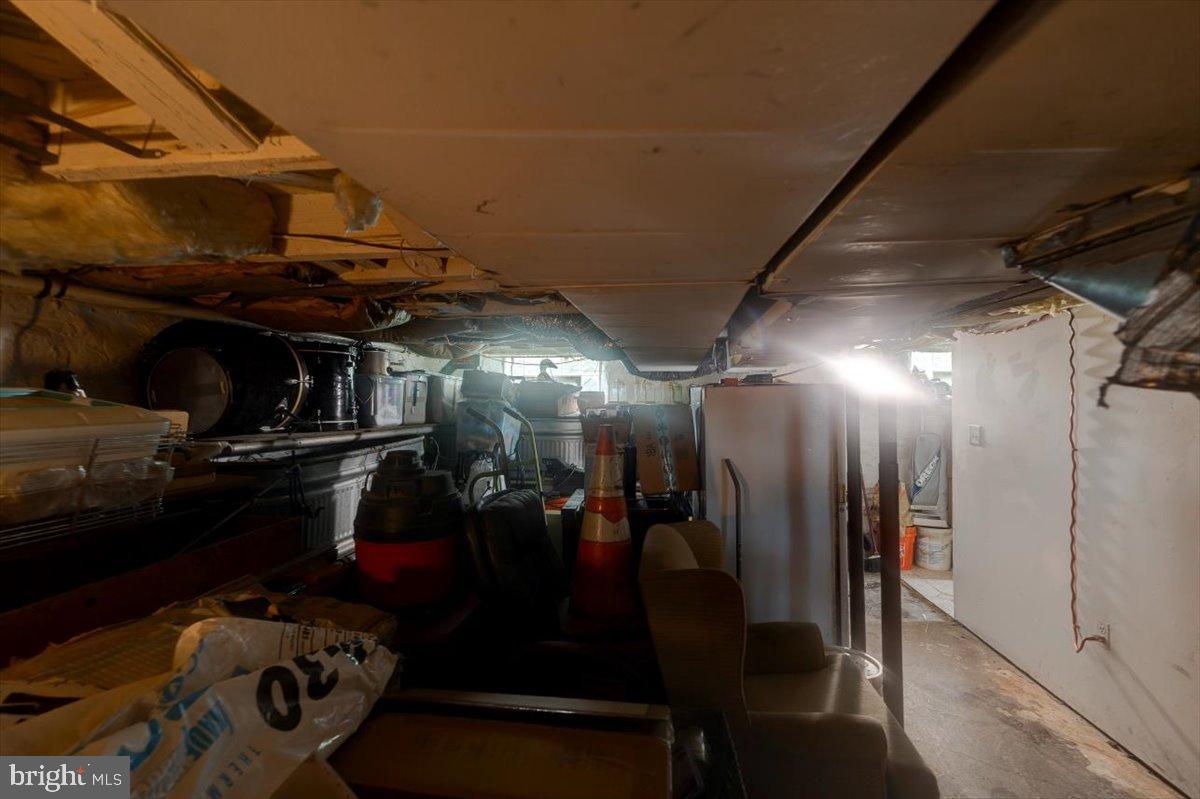 7306 Dogwood Road Baltimore, MD 21244 - Photo 36 of 37 Dimly lit basement with cluttered storage.