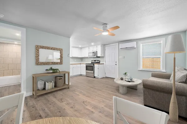 a living room with furniture and a kitchen