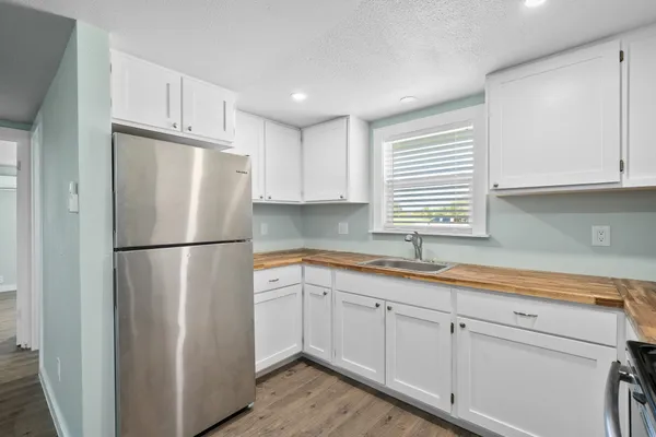 a white refrigerator freezer sitting inside of a kitchen