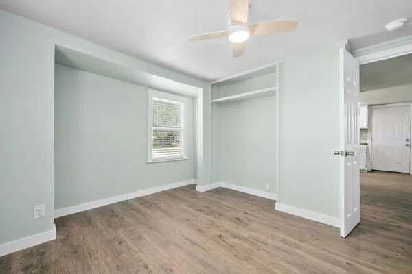 wooden floor in an empty room with a window