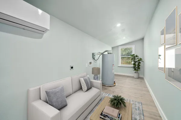 a living room with furniture and a wooden floor