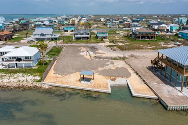 an aerial view of a house with a swimming pool yard and outdoor seating