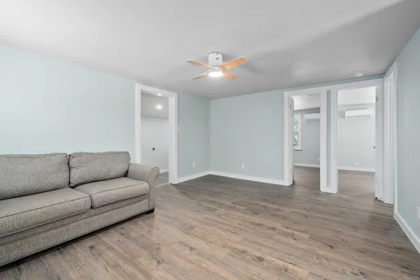 a living room with furniture and wooden floor
