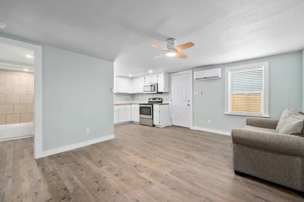 a view of kitchen with furniture and wooden floor