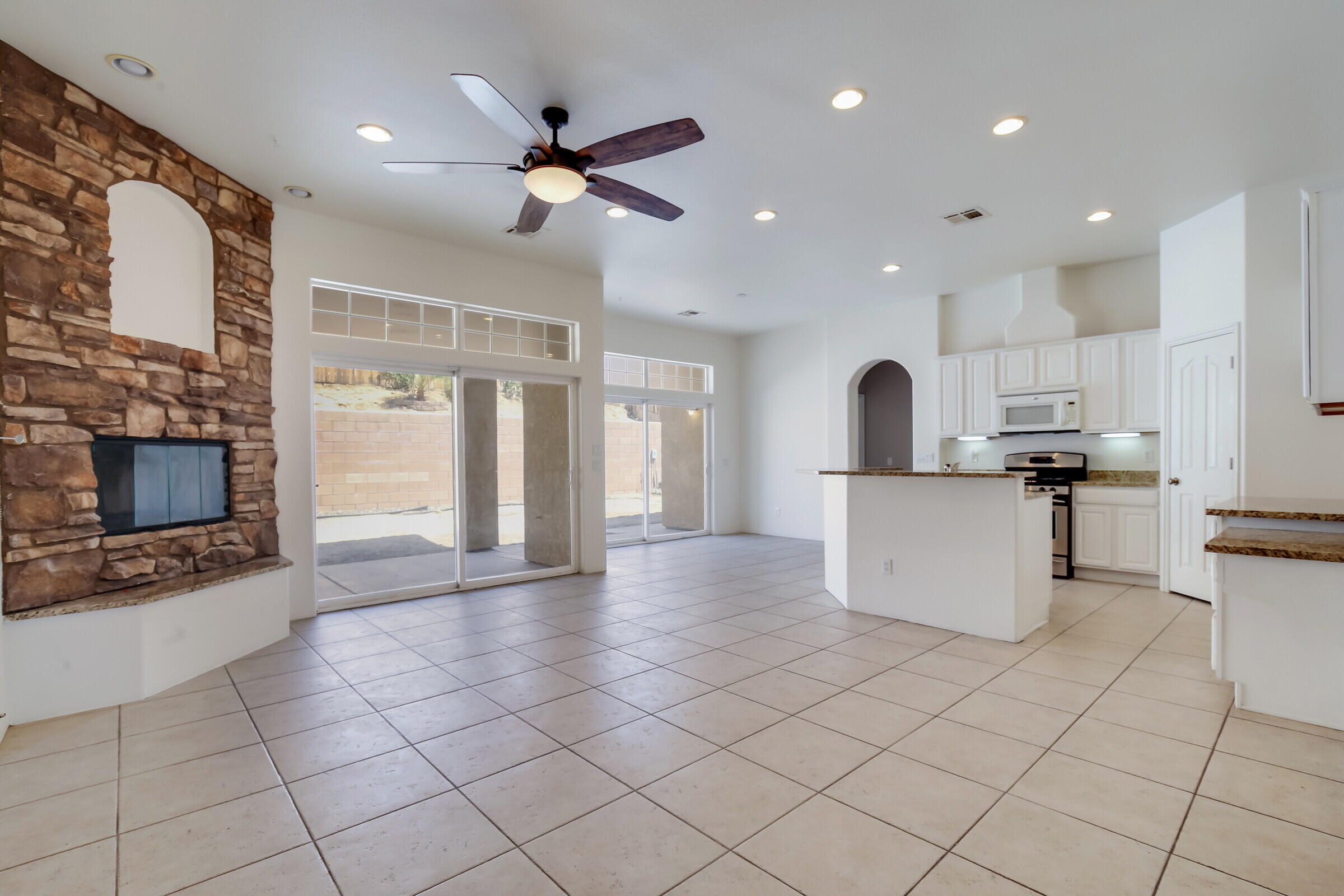 10748 Ocotillo Road Desert Hot Springs, CA 92240 - Photo 2 of 28 a view of a kitchen with kitchen island white cabinets and stainless steel appliances