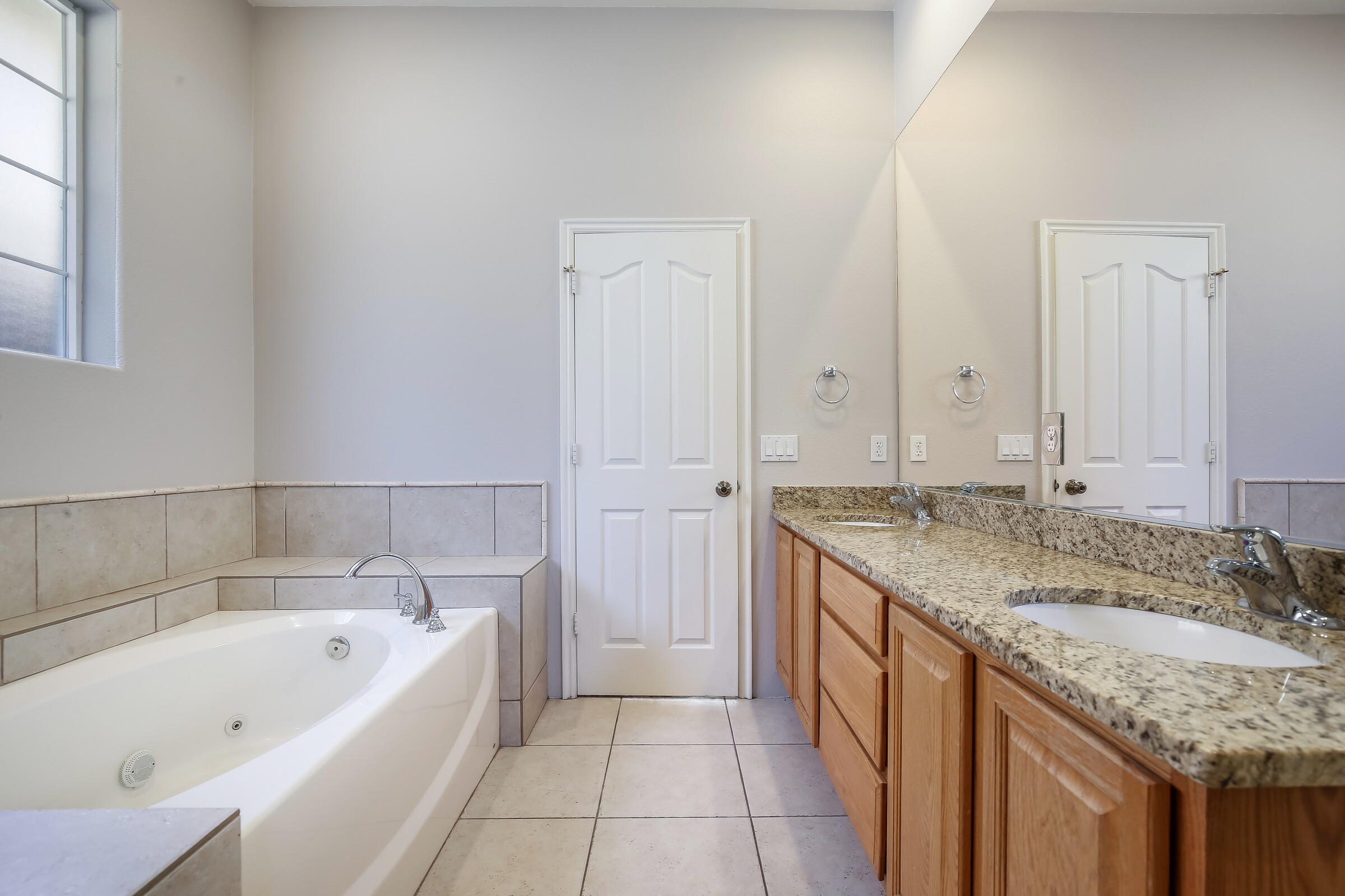 10748 Ocotillo Road Desert Hot Springs, CA 92240 - Photo 16 of 28 a bathroom with a granite countertop bathtub a sink and a