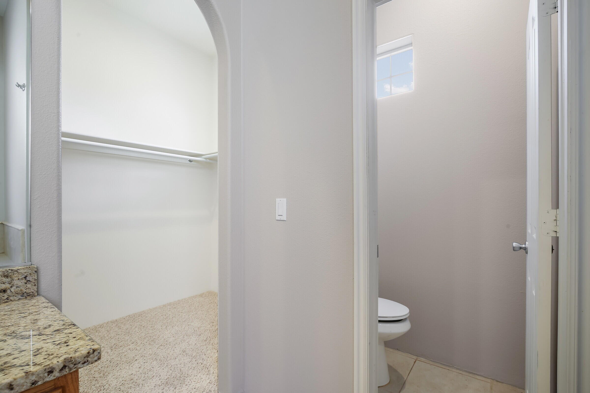 10748 Ocotillo Road Desert Hot Springs, CA 92240 - Photo 17 of 28 a bathroom with a granite countertop toilet and a sink