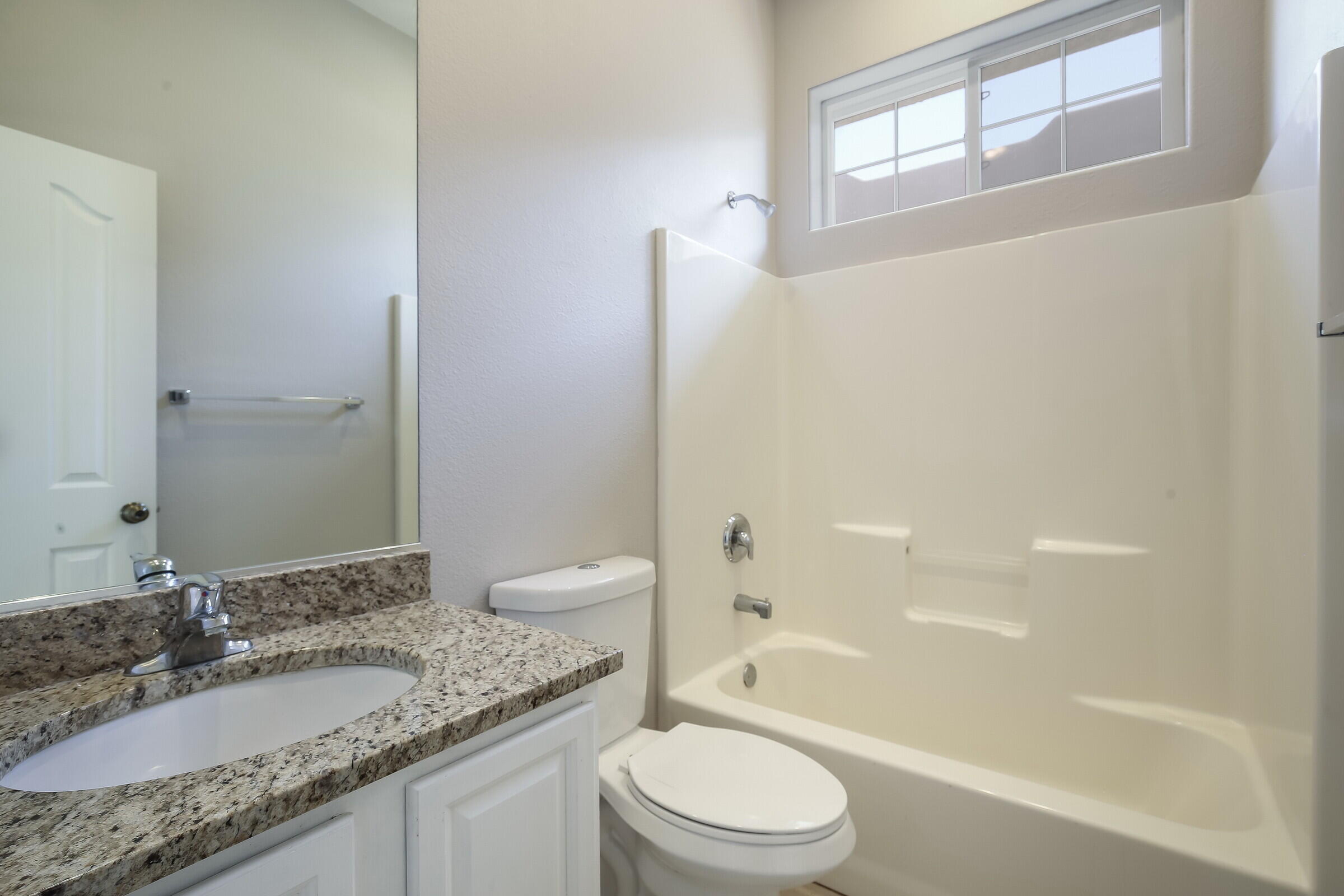 10748 Ocotillo Road Desert Hot Springs, CA 92240 - Photo 22 of 28 a bathroom with a granite countertop sink toilet and shower