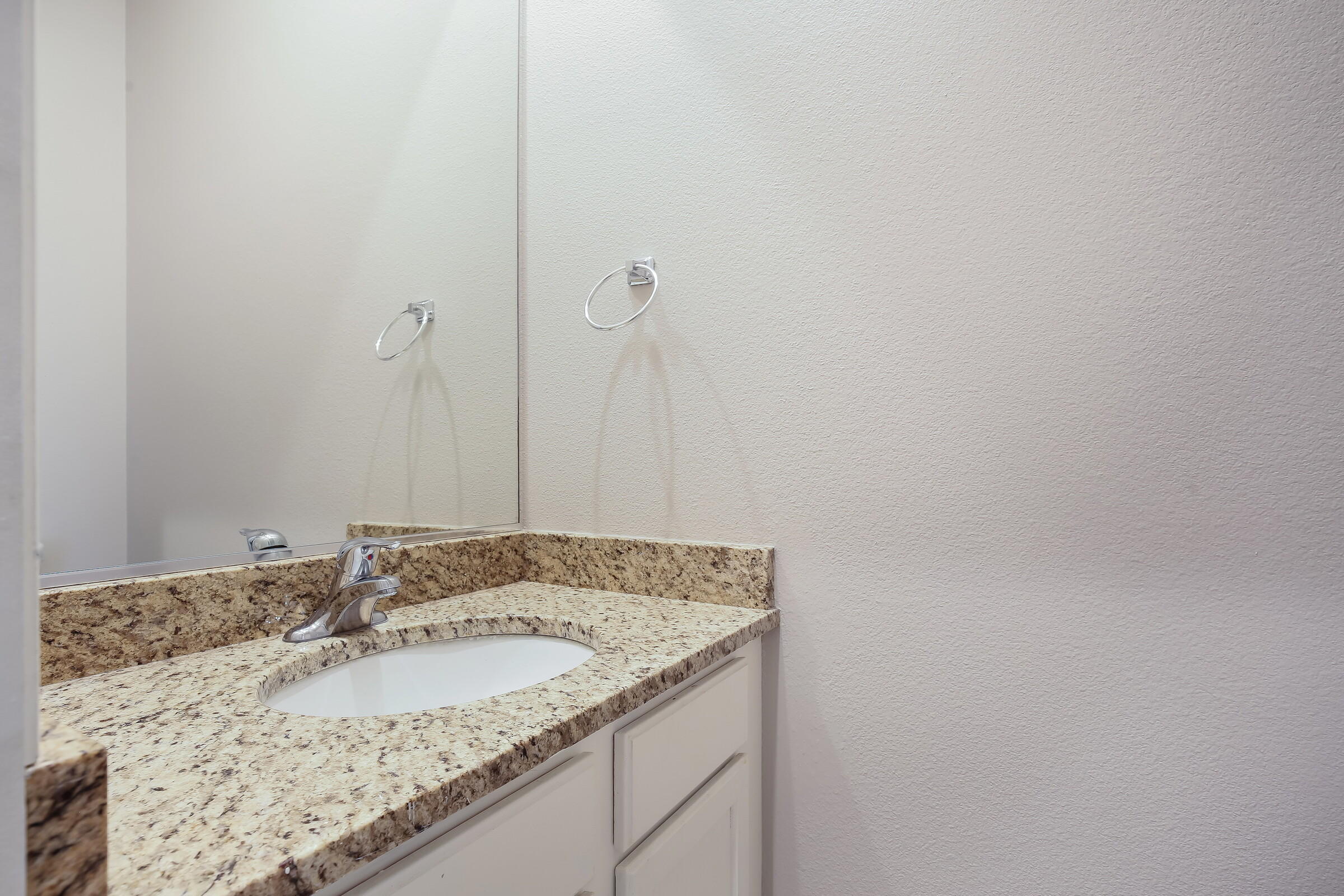 10748 Ocotillo Road Desert Hot Springs, CA 92240 - Photo 10 of 28 a bathroom with a granite countertop sink and vanity