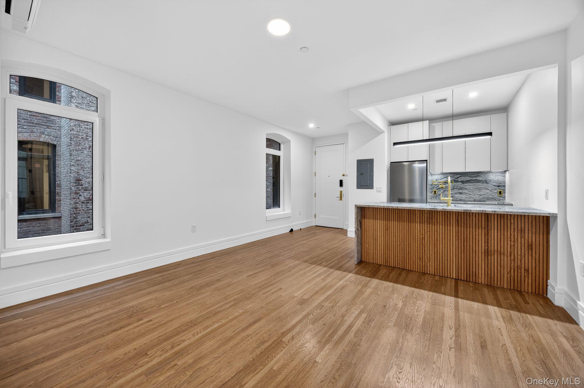 60 West 129th Street, Unit 409 Manhattan, NY 10027 - Photo 2 of 17 a view of kitchen with granite countertop cabinets and wooden floor