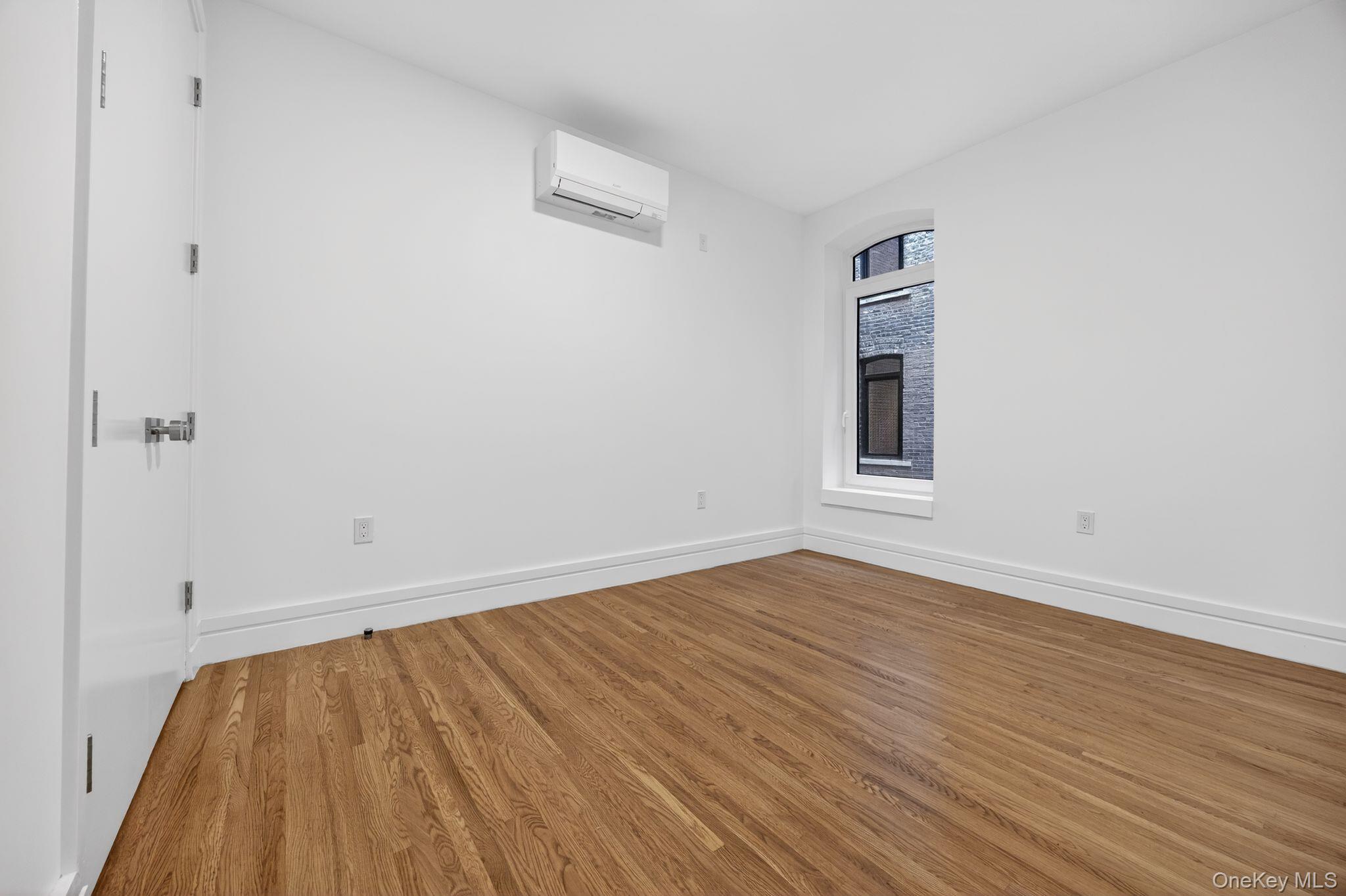60 West 129th Street, Unit 409 Manhattan, NY 10027 - Photo 5 of 17 wooden floor in an empty room