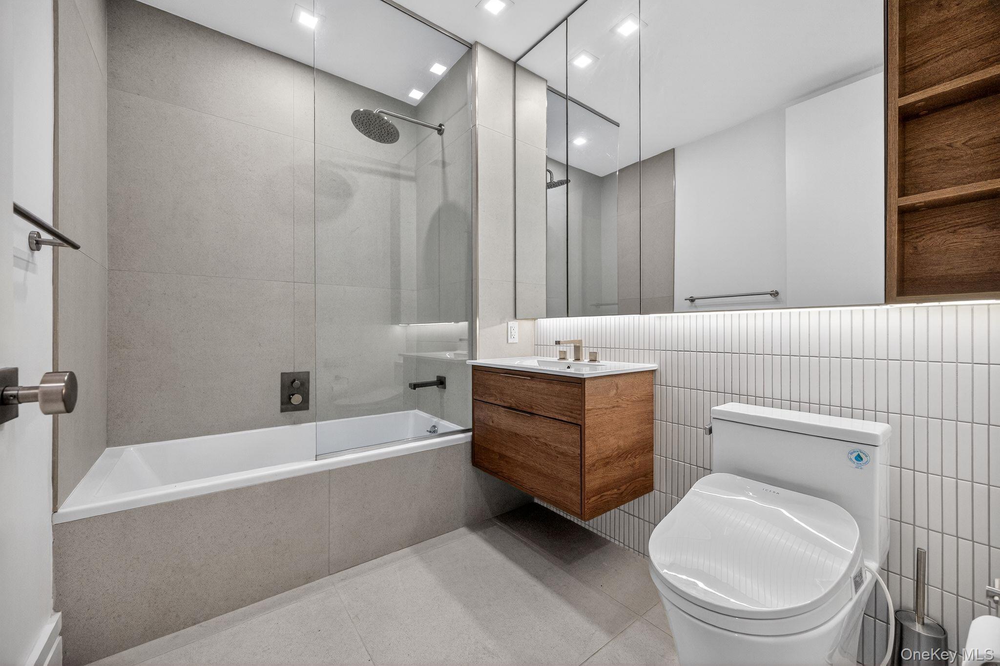 60 West 129th Street, Unit 409 Manhattan, NY 10027 - Photo 8 of 17 a bathroom with a bathtub toilet and shower