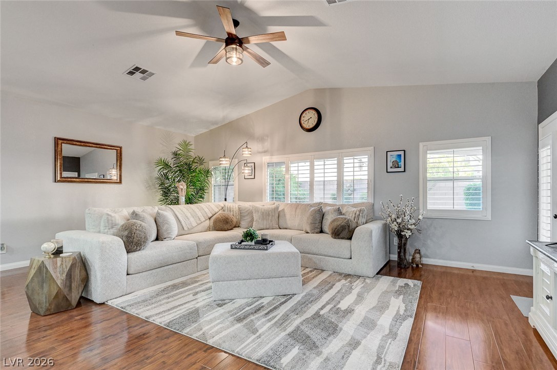 1604 Cattle Ranch Place Henderson, NV 89002 - Photo 26 of 99 Hardwood floors and a vaulted ceiling elevate this comfortable living space.