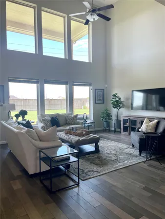 a living room with furniture and a large window