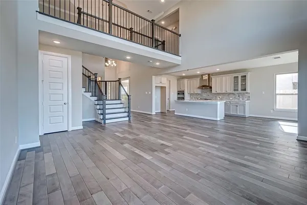 a view of a living room and kitchen with furniture wooden floor and window