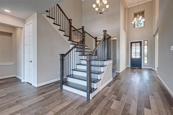 a view of entryway and hall with wooden floor