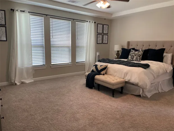 a spacious bedroom with a bed and a couch