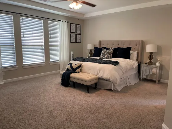 a spacious bedroom with a bed and a window