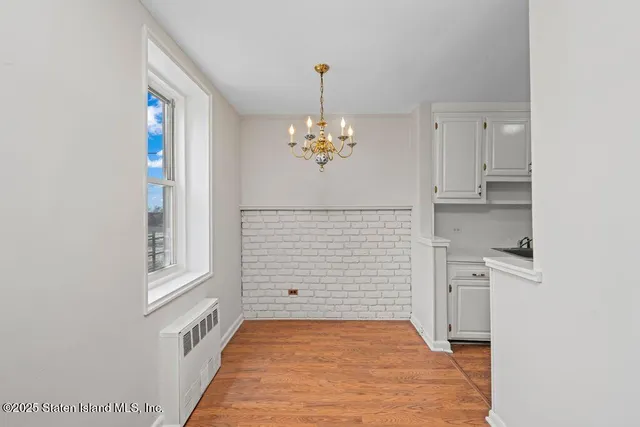 a view of a hallway with chandelier and entryway