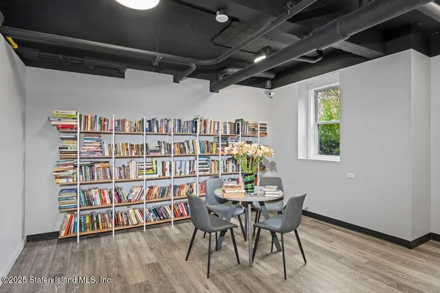a view of a dining room with furniture and a book shelf