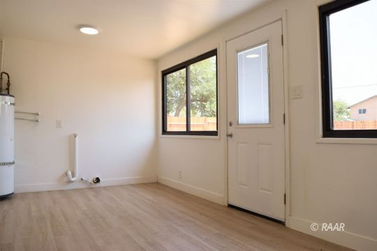 204 North Helena Street Ridgecrest, CA 93555 - Photo 10 of 29 a view of an empty room with wooden floor and a window