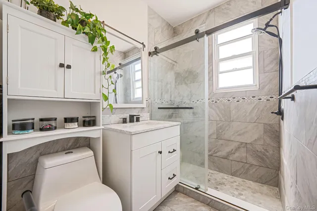 a bathroom with a sink a toilet and shower