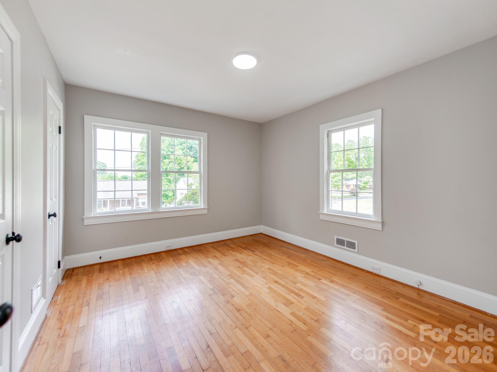 113 Falls Street Morganton, NC 28655 - Photo 13 of 33 an empty room with wooden floor and windows
