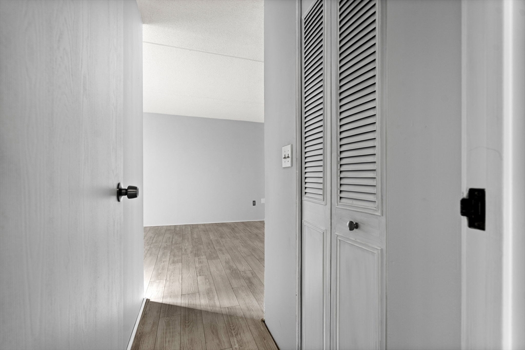 159 Franklin Street, Unit E6 Stoneham, MA 02180 - Photo 19 of 22 a view of a room with wooden floor