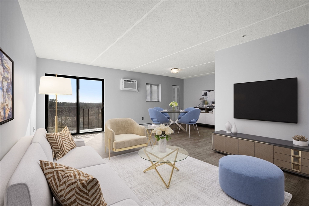 159 Franklin Street, Unit E6 Stoneham, MA 02180 - Photo 3 of 22 a living room with furniture and a flat screen tv