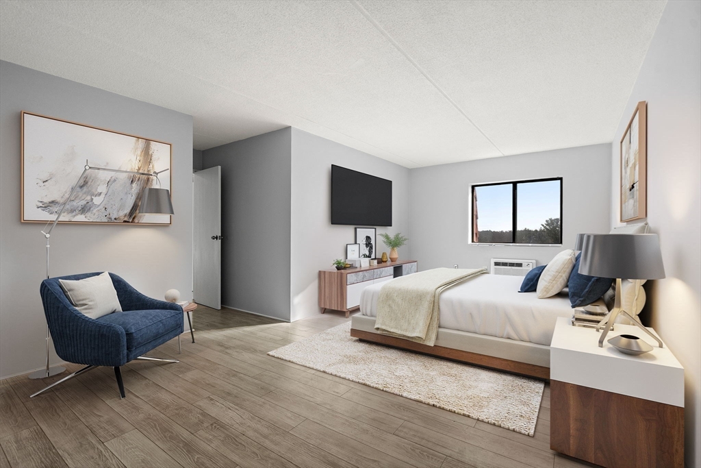 159 Franklin Street, Unit E6 Stoneham, MA 02180 - Photo 4 of 22 a room with a bed and a chair