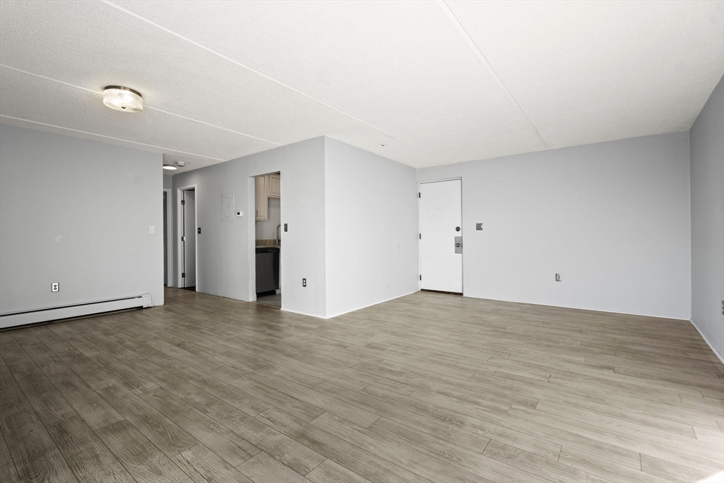 159 Franklin Street, Unit E6 Stoneham, MA 02180 - Photo 8 of 22 a view of an empty room with wooden floor