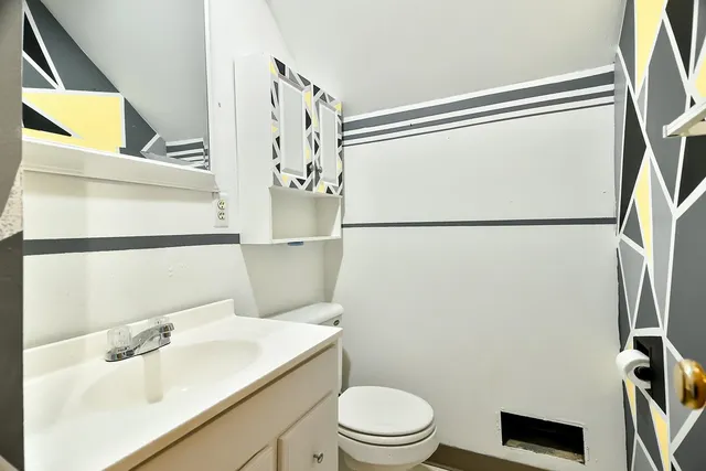 a white toilet sitting next to a bathroom sink