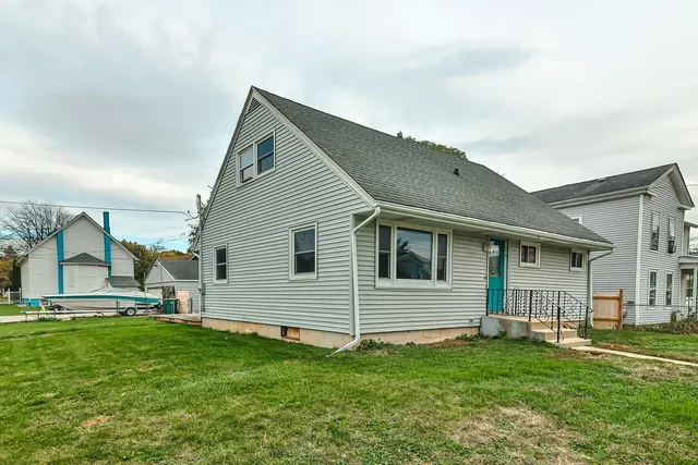 a backyard of a house with table and chairs