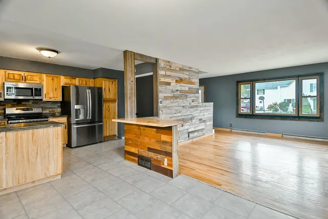 a view of kitchen with furniture and refrigerator