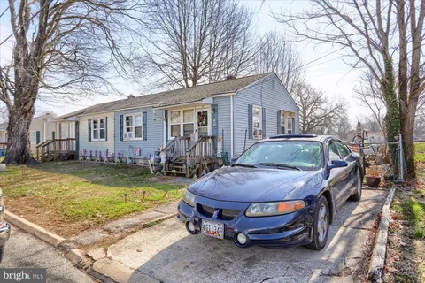 a view of a house with swimming pool and sitting area