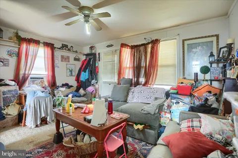 a living room filled with furniture and a chandelier