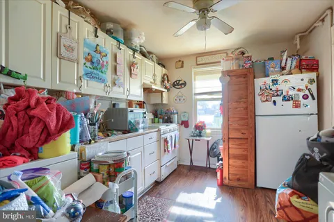 a storage room with lots of stuff and hardwood floor