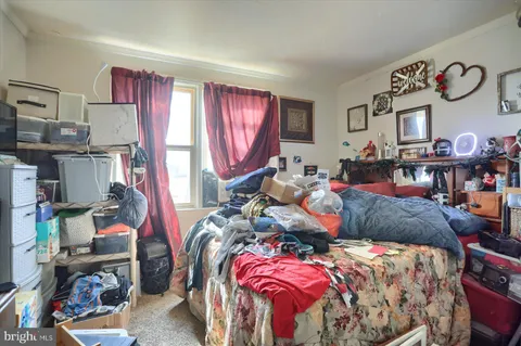 a bed room with a bed next to a window