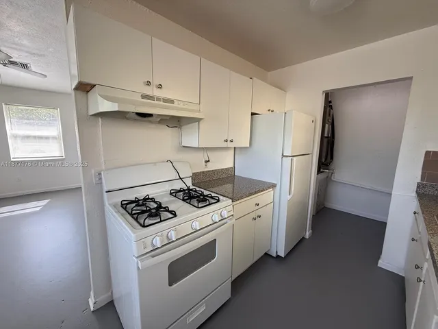 a kitchen that has a sink and a stove