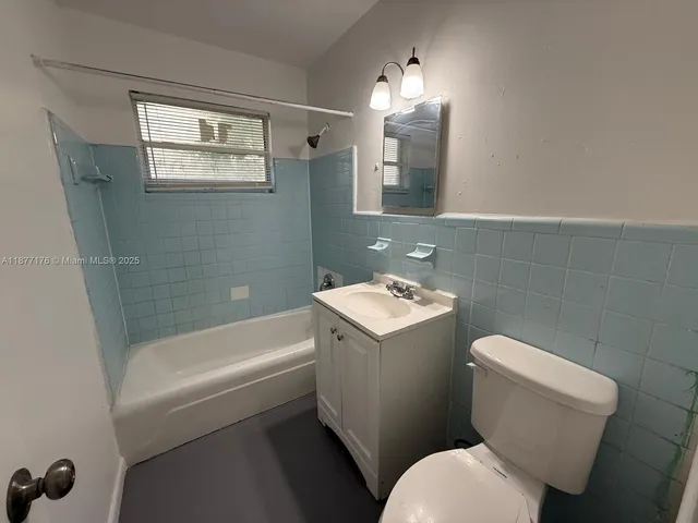 an empty room with a chandelier fan and closet